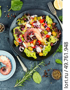 Plate of octopus tentacles, olives and potatoes. Octopus salad. Top view. Seafood.. Potato salad with octopus. Стоковое фото, агентство Ingram Publishing / Фотобанк Лори