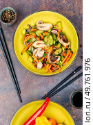 Fresh and healthy salad Asian seafood squid with vegetables and chopstick. Top view.. Spicy squid vegetables with in plate on table. Стоковое фото, агентство Ingram Publishing / Фотобанк Лори