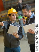 satisfied manager discussing job with worker at pvc windows factory. Стоковое фото, агентство Ingram Publishing / Фотобанк Лори