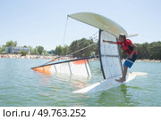 salior trying to right his catamaran after capsize. Стоковое фото, агентство Ingram Publishing / Фотобанк Лори