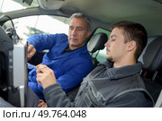 student with instructor repairing a car during apprenticeship. Стоковое фото, агентство Ingram Publishing / Фотобанк Лори