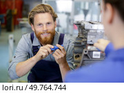 craftsman using a machine in a factory. Стоковое фото, агентство Ingram Publishing / Фотобанк Лори