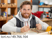 electrician examining current voltage with screwdriver tester. Стоковое фото, агентство Ingram Publishing / Фотобанк Лори