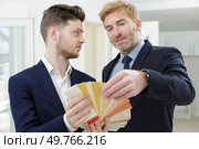 interior designers teamwork with pantone swatch and house building plans. Стоковое фото, агентство Ingram Publishing / Фотобанк Лори