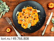 Pumpkin ravioli with sage on rustic wooden table. Ravioli filled with butternut squash and topped with sage. Top view.. Homemade Butternut Squash Ravioli. Стоковое фото, агентство Ingram Publishing / Фотобанк Лори