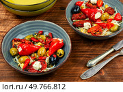 A delicious salad of pickled soybean sprouts, dried tomatoes, olives and peppers on rustic wooden table. Chinese food.. Vegan Salad of Pickled Vegetables and Soybeans. Стоковое фото, агентство Ingram Publishing / Фотобанк Лори