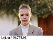 A woman elegantly dressed in a fitted blazer and a stylish turtleneck stands in a softfocus background, appearing pensive and introspective, her demeanor conveying a depth of emotions that resonate. A Contemplative Woman Dressed in Neutral Tones and Captured in a ThoughtProvoking Atmosphere. Стоковое фото, агентство Ingram Publishing / Фотобанк Лори