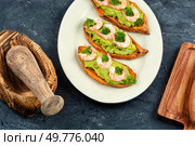 Roasted sweet potato, yam stuffed with prawns and avocado on a concrete kitchen table.. Baked, Stuffed Sweet Potatoes. Стоковое фото, агентство Ingram Publishing / Фотобанк Лори