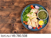 Seasoning raw chicken meat with salt and herbs. Marinating meat for cooking.. Raw marinated chicken meat cilantro herb. Стоковое фото, агентство Ingram Publishing / Фотобанк Лори
