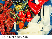 Starter of green olives, black olives, capers, sun dried tomatoes and cheese. Close up.. Greek antipasti snacks set. Стоковое фото, агентство Ingram Publishing / Фотобанк Лори