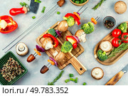 Sliced raw vegetables on skewers, shish kabob. Preparation of vegetable skewers. Uncooked shashlik.. Tasty kebab on skewers with vegetables. Стоковое фото, агентство Ingram Publishing / Фотобанк Лори