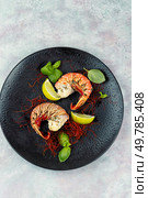 Two lobster tails on plate with spices for dinner. Holidays food concept. Steamed Lobster Tail, Luxury Food. Стоковое фото, агентство Ingram Publishing / Фотобанк Лори