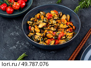 Fried mussels with spices and sauce on a concrete kitchen table. Seafood.. Fresh cooked mussels. Стоковое фото, агентство Ingram Publishing / Фотобанк Лори