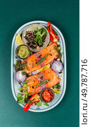 Two uncooked, raw salmon fillets. Spices, sauces and herbs. Fish fillet of salmon and ingredients. Стоковое фото, агентство Ingram Publishing / Фотобанк Лори