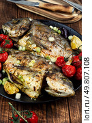 Delicious tasty baked dorado or sea bream fish with lime. Healthy eating.. Grilled sea bream or dorada. Стоковое фото, агентство Ingram Publishing / Фотобанк Лори