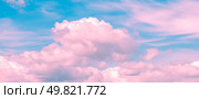 Pink and turquoise hues blend seamlessly in a sky filled with wispy cirrus clouds and fluffy cumulus formations, creating a dreamy and ethereal atmosphere. Стоковое фото, фотограф Ольга Ильина / Фотобанк Лори