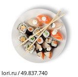 Sushi and rolls in a plate with sticks isolated on a white background. Clipping path. Стоковое фото, агентство Ingram Publishing / Фотобанк Лори