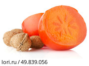 Ripe persimmons and nuts on white background. Стоковое фото, агентство Ingram Publishing / Фотобанк Лори