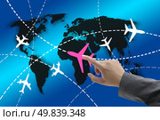 hand touch on planes with routes around the world for business travel concept. Стоковое фото, агентство Ingram Publishing / Фотобанк Лори