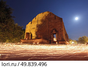 candle light trail of Buddhism Ceremony at temple ruin with moon on Asalha Puja Day. Стоковое фото, агентство Ingram Publishing / Фотобанк Лори