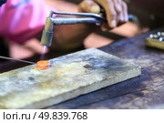 Goldsmith working with a thai traditional ring. Стоковое фото, агентство Ingram Publishing / Фотобанк Лори