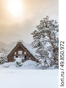 Shirakawago with Snowfall and winter Sun,  Gifu Chubu Japan. Стоковое фото, агентство Ingram Publishing / Фотобанк Лори