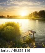 Wooden fishing pier by the river at sunrise. Стоковое фото, агентство Ingram Publishing / Фотобанк Лори