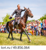 Russia, Samara, June 2016: A dashing Cossack on horseback during a demonstration performance at the Journey to the Past festival. Редакционное фото, фотограф Акиньшин Владимир / Фотобанк Лори