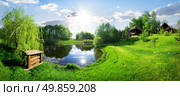 Wooden house near river at sunny day. Стоковое фото, агентство Ingram Publishing / Фотобанк Лори