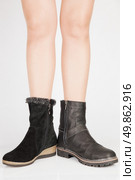Beautiful female legs in the different leather boots with buckles. Стоковое фото, агентство Ingram Publishing / Фотобанк Лори