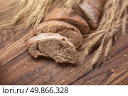 Bread and wheat on wooden table, shallow DOF, raw image. Стоковое фото, агентство Ingram Publishing / Фотобанк Лори