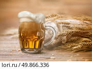 Bread and wheat on wooden table, shallow DOF, raw image. Стоковое фото, агентство Ingram Publishing / Фотобанк Лори
