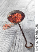 saffron in old spoon on wooden backgound. saffron in spoon on wooden backgound. Стоковое фото, агентство Ingram Publishing / Фотобанк Лори