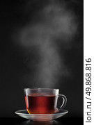 cup with hot tea and steam on black. Стоковое фото, агентство Ingram Publishing / Фотобанк Лори
