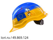 Blue and yellow hard hat with cracks, scratches and EU flag. KIEV, UKRAINE - DECEMBER 1: Ukraine police smash pro-Europe protest on Euromaydan in Kiev, Ukraine. Стоковое фото, агентство Ingram Publishing / Фотобанк Лори