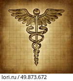 Caduceus on an old grunge parchment document as a vintage medical symbol and health care and medicine icon with snakes crawling on a pole with wings as a pharmacy medicine concept. Стоковое фото, агентство Ingram Publishing / Фотобанк Лори