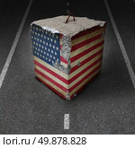 United States government shutdown roadblock obstacle and barrier business concept with a huge cement or concrete cube with an old American flag blocking a road or highway as a symbol of political gridlock resulting in financial system shutdown. Стоковое фото, агентство Ingram Publishing / Фотобанк Лори