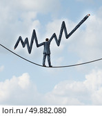 Balanced investing and financial advice business concept as a businessman walking on a tightrope with extended arms shaped in a profits finance graph as a metaphor for wealth management. Стоковое фото, агентство Ingram Publishing / Фотобанк Лори