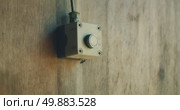 Finger presses button on wooden wall used to control target movement at shooting range during training session. Стоковое видео, видеограф Igor Tichonow / Фотобанк Лори