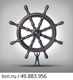 Take the reins and change course business concept as a businessman holding a ship wheel steering gear as a symbol and financial metaphor for taking control and directing the future for success. Стоковое фото, агентство Ingram Publishing / Фотобанк Лори