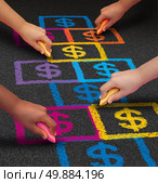 School financing and education business concept as a group of children drawing a hopscotch game on a floor with dollar signs as a symbol of student loans and paying for schooling fees. Стоковое фото, агентство Ingram Publishing / Фотобанк Лори