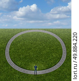 Going in circles and career problems business concept with no change in status as a businessman on a pointless circular repeating road as a symbol of stagnation and wasted time by following a useless path to nowhere. Стоковое фото, агентство Ingram Publishing / Фотобанк Лори