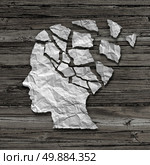 Alzheimer patient medical mental health care concept as a sheet of torn crumpled white paper shaped as a side profile of a human face on an old grungy wood background as a symbol for neurology and dementia issues or memory loss. Стоковое фото, агентство Ingram Publishing / Фотобанк Лори