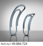 Office bullying and bullies in the workplace concept as two paperclips with one intimidating another as a corporate bully metaphor and worker management. Стоковое фото, агентство Ingram Publishing / Фотобанк Лори