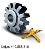 Business danger concept and risk ahead symbol or work injury and worker compensation claim due to working hazard as a gear wheel or cog rolling on to a slippery banana peel. Стоковое фото, агентство Ingram Publishing / Фотобанк Лори