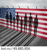 American immigration and United States refugee crisis concept as people on a border wall with a US flag as a social issue about refugees or illegal immigrants with the cast shadow of a group of migrating women men and children.

. Стоковое фото, агентство Ingram Publishing / Фотобанк Лори