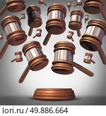 Class action lawsuit concept as a plaintiff group represented by many judge mallets or gavel icons coming down as a symbol for social litigation or organized legal legislation. Стоковое фото, агентство Ingram Publishing / Фотобанк Лори