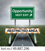 Restricted opportunity concept and business road block symbol as a barrier with text barring entrance to a road with a sign for opportunities as a metaphor for discrimination or unfair limited corporate world. Стоковое фото, агентство Ingram Publishing / Фотобанк Лори