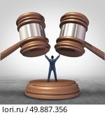 Mediation resolution and mediate legal disputes in business as a concept with a businessman or lawyer separating two judge mallets or gavel as competitors in arbitration. Стоковое фото, агентство Ingram Publishing / Фотобанк Лори