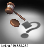 Law question concept and court questions symbol and legal advice icon as a judge gavel or mallet with a sound block falling casting a shadow shaped as a question mark representing uncertainty in legality issues. Стоковое фото, агентство Ingram Publishing / Фотобанк Лори